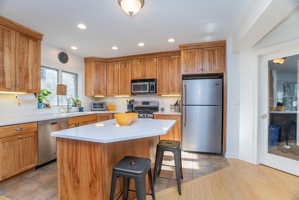 642 North Farms Road Northampton, MA 01062 - Photo 8 of 42 a kitchen with stainless steel appliances granite countertop a refrigerator a sink a stove a dining table and chairs