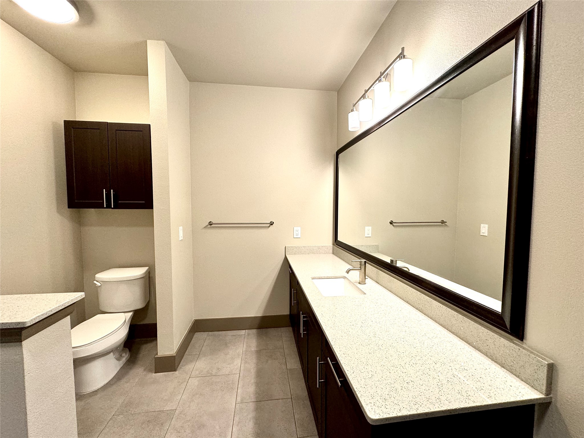 2033 South Gessner Road, Unit 2105 Houston, TX 77063 - Photo 11 of 23 a bathroom with a toilet a sink and mirror