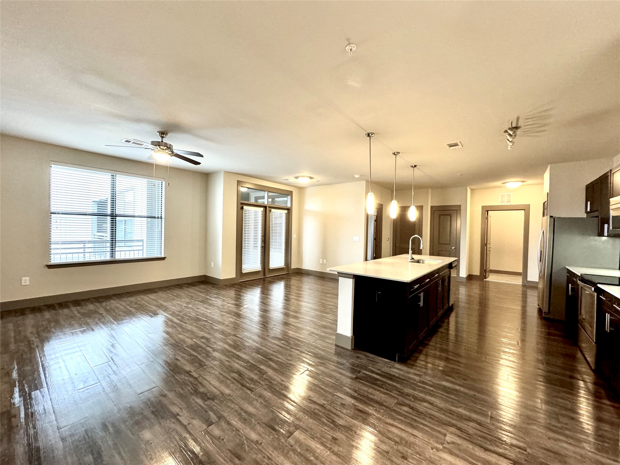 2033 South Gessner Road, Unit 2105 Houston, TX 77063 - Photo 2 of 23 an open kitchen with wooden floor and a sink