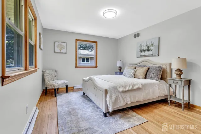 a spacious bedroom with a bed and a large window