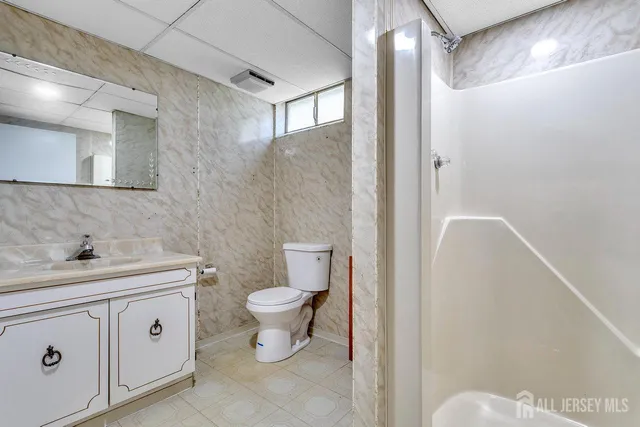 a bathroom with a toilet sink and a mirror