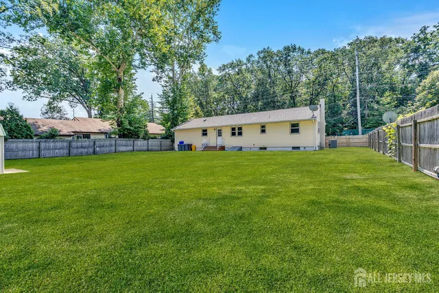 a view of a house with backyard and a sitting area