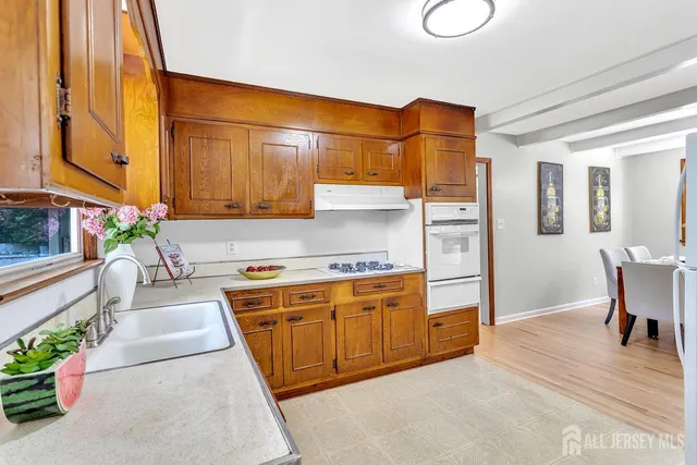 a kitchen with stainless steel appliances granite countertop a sink and cabinets