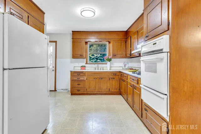 a kitchen with stainless steel appliances a refrigerator sink and cabinets
