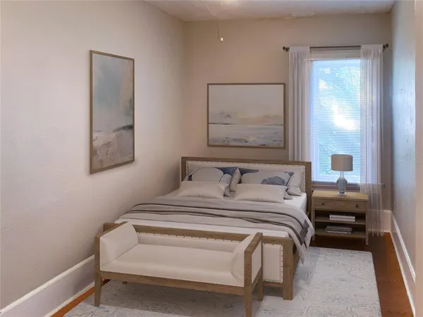 a bedroom with a bed and a painting on the wall