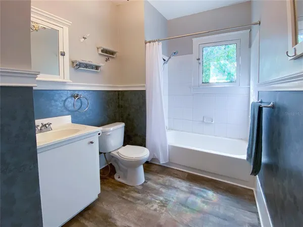 a bathroom with a toilet a sink and bathtub