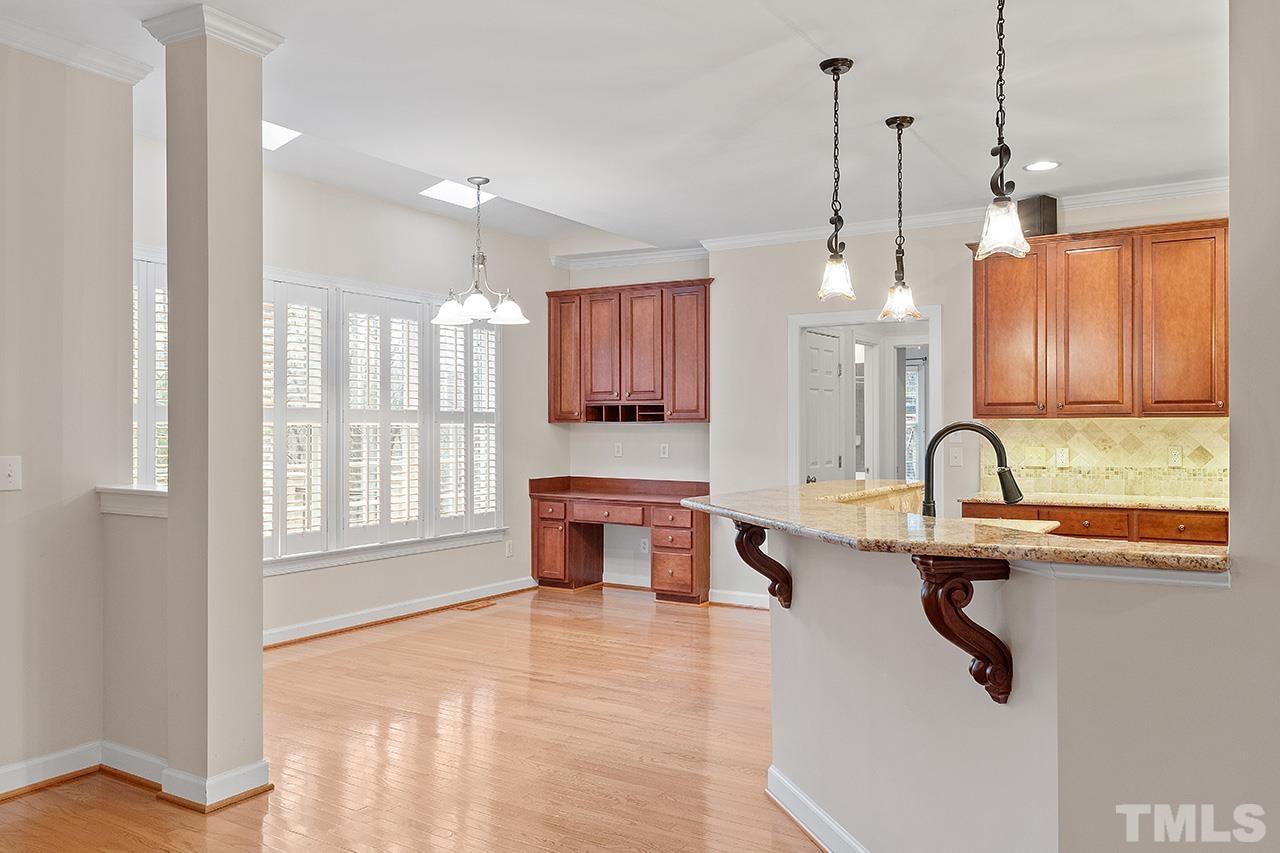 12724 Amoretto Way Raleigh, NC 27613 - Photo 14 of 44 a kitchen with stainless steel appliances granite countertop a sink a stove and a window