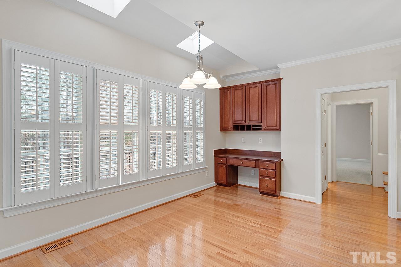 12724 Amoretto Way Raleigh, NC 27613 - Photo 15 of 44 a view of an empty room with a window and kitchen view