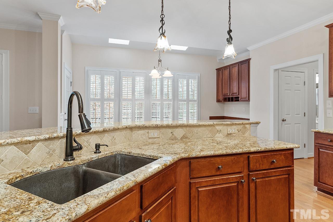 12724 Amoretto Way Raleigh, NC 27613 - Photo 22 of 44 a kitchen with granite countertop a sink and a window