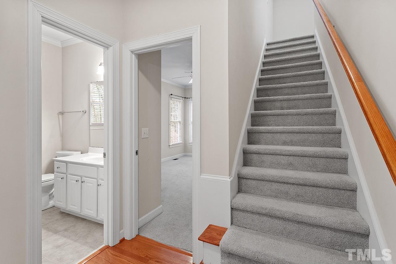 12724 Amoretto Way Raleigh, NC 27613 - Photo 23 of 44 a view of an entryway with wooden floor and staircase