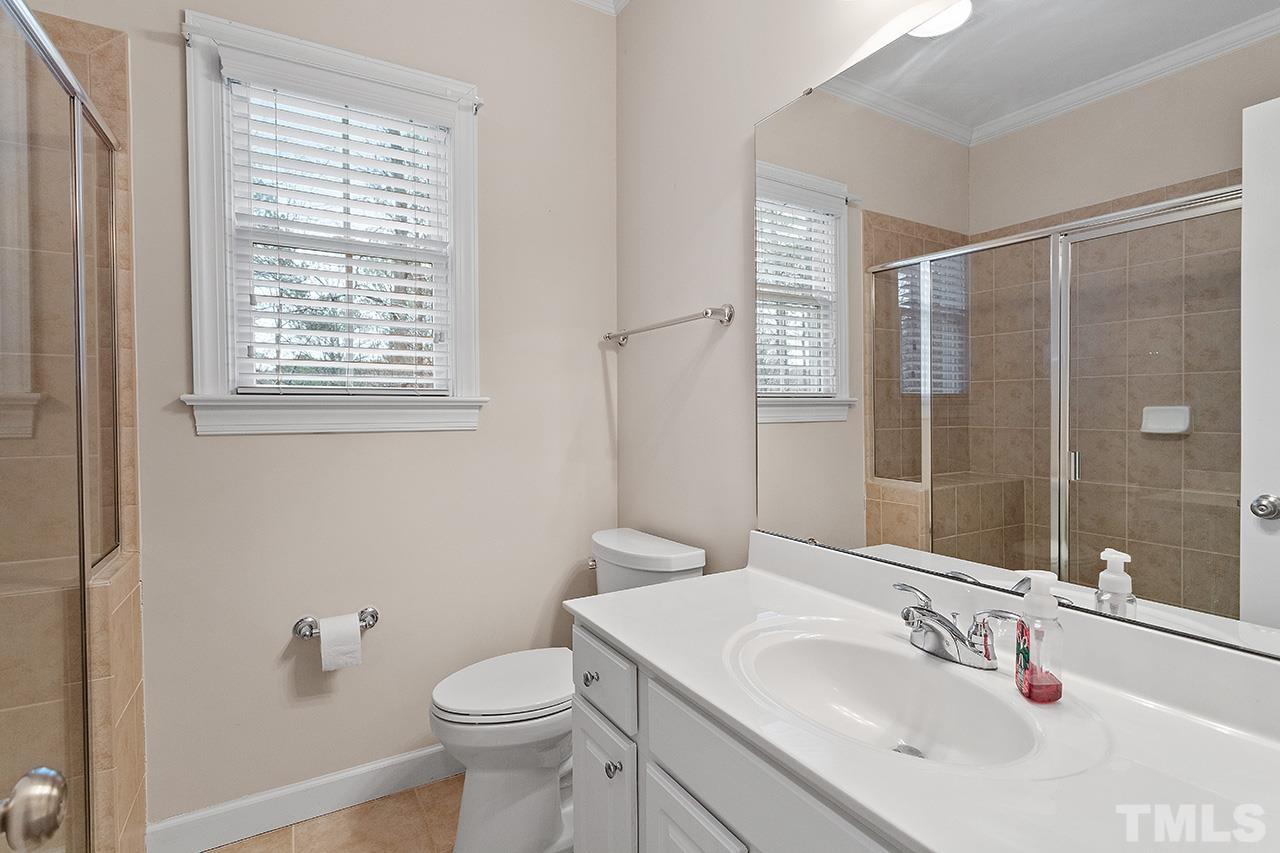 12724 Amoretto Way Raleigh, NC 27613 - Photo 25 of 44 a bathroom with a sink toilet and shower