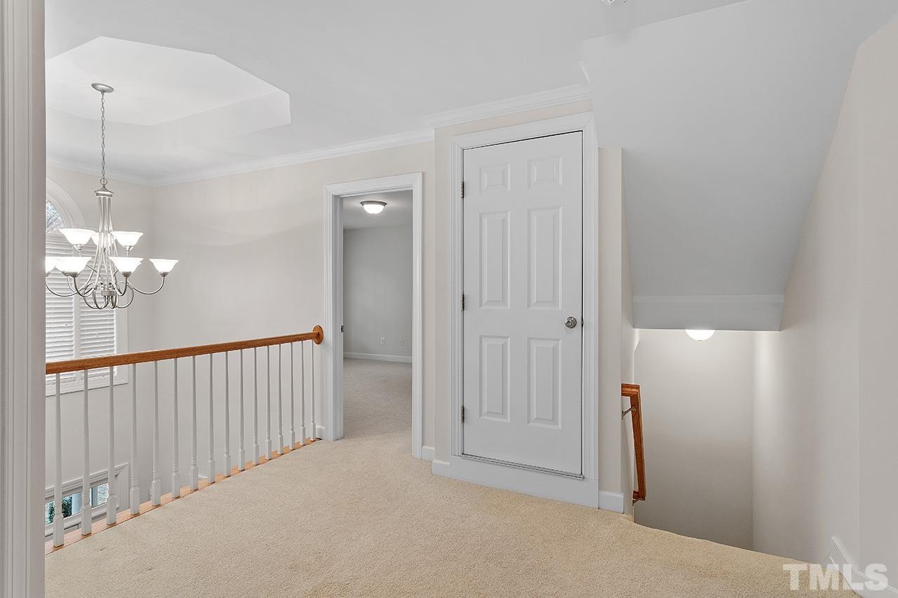 12724 Amoretto Way Raleigh, NC 27613 - Photo 26 of 44 a view of a hallway with a chandelier fan