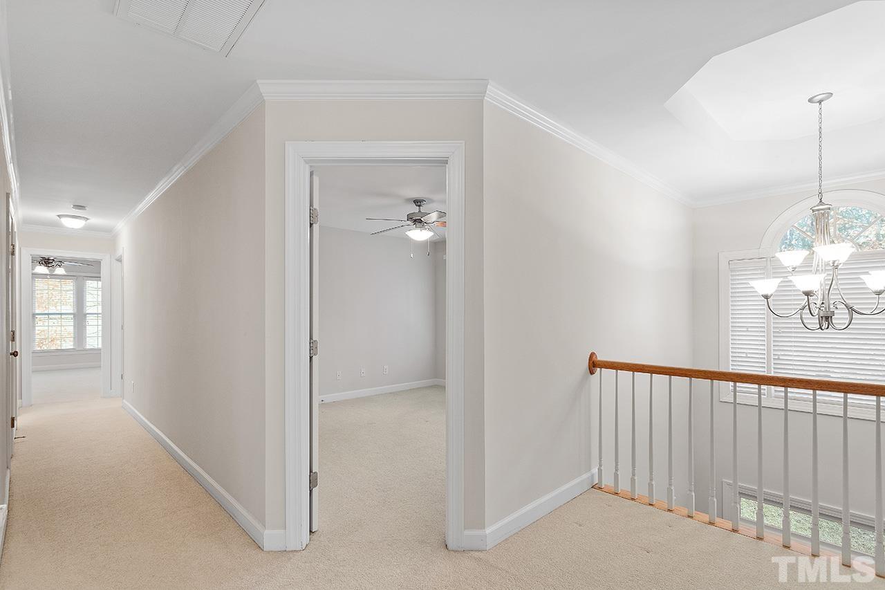 12724 Amoretto Way Raleigh, NC 27613 - Photo 27 of 44 a view of a hallway to a livingroom with wooden floor