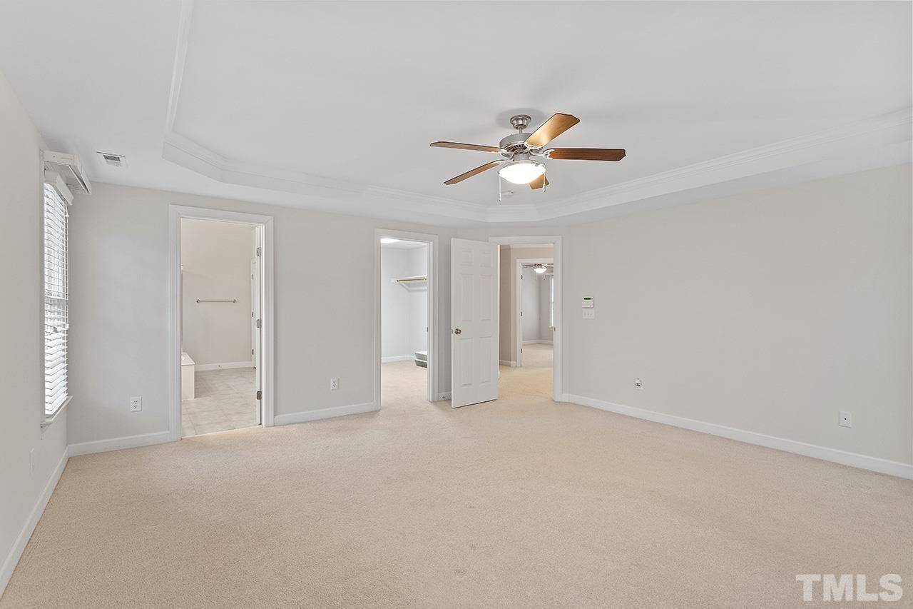 12724 Amoretto Way Raleigh, NC 27613 - Photo 29 of 44 an empty room with chandelier fan and window