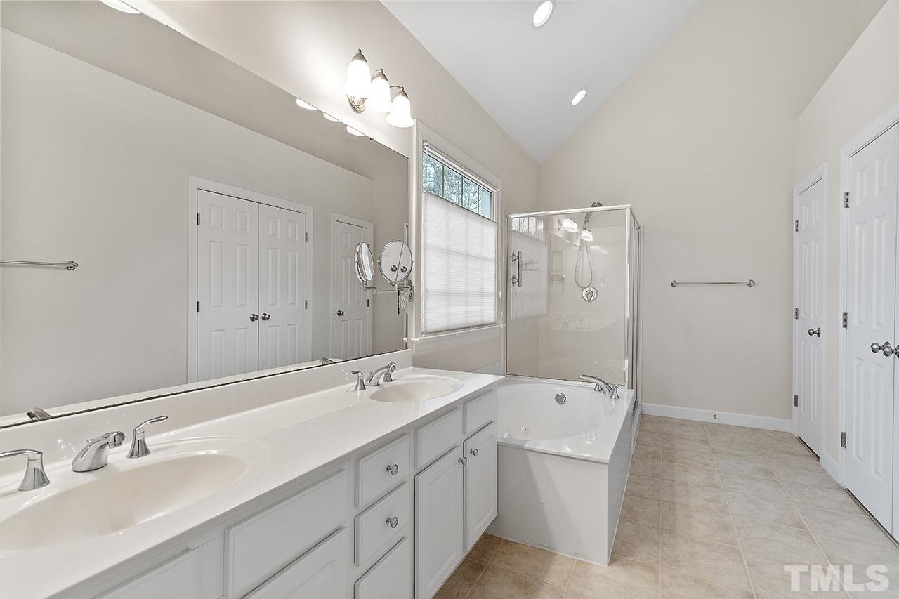 12724 Amoretto Way Raleigh, NC 27613 - Photo 31 of 44 a spacious bathroom with a double vanity sink mirror double and shower