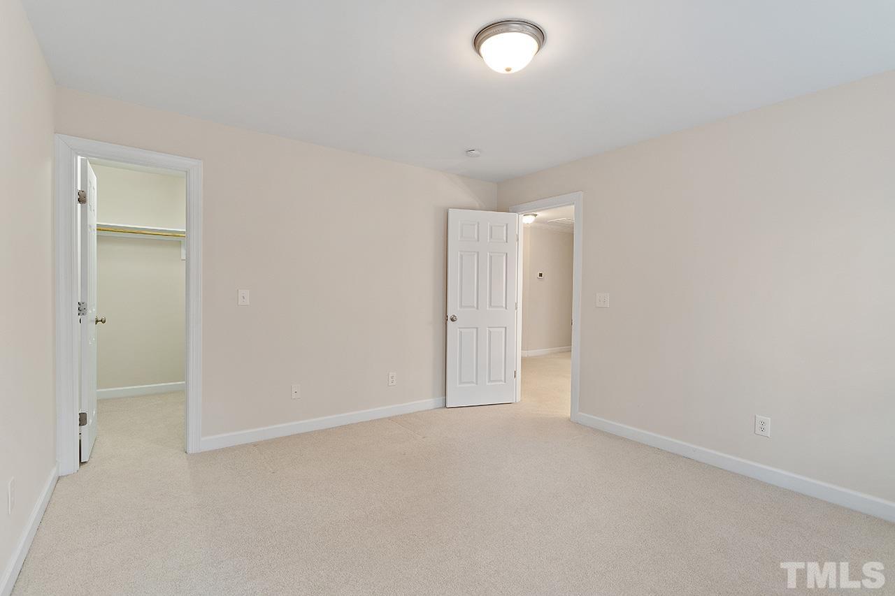12724 Amoretto Way Raleigh, NC 27613 - Photo 33 of 44 an empty room with an entryway