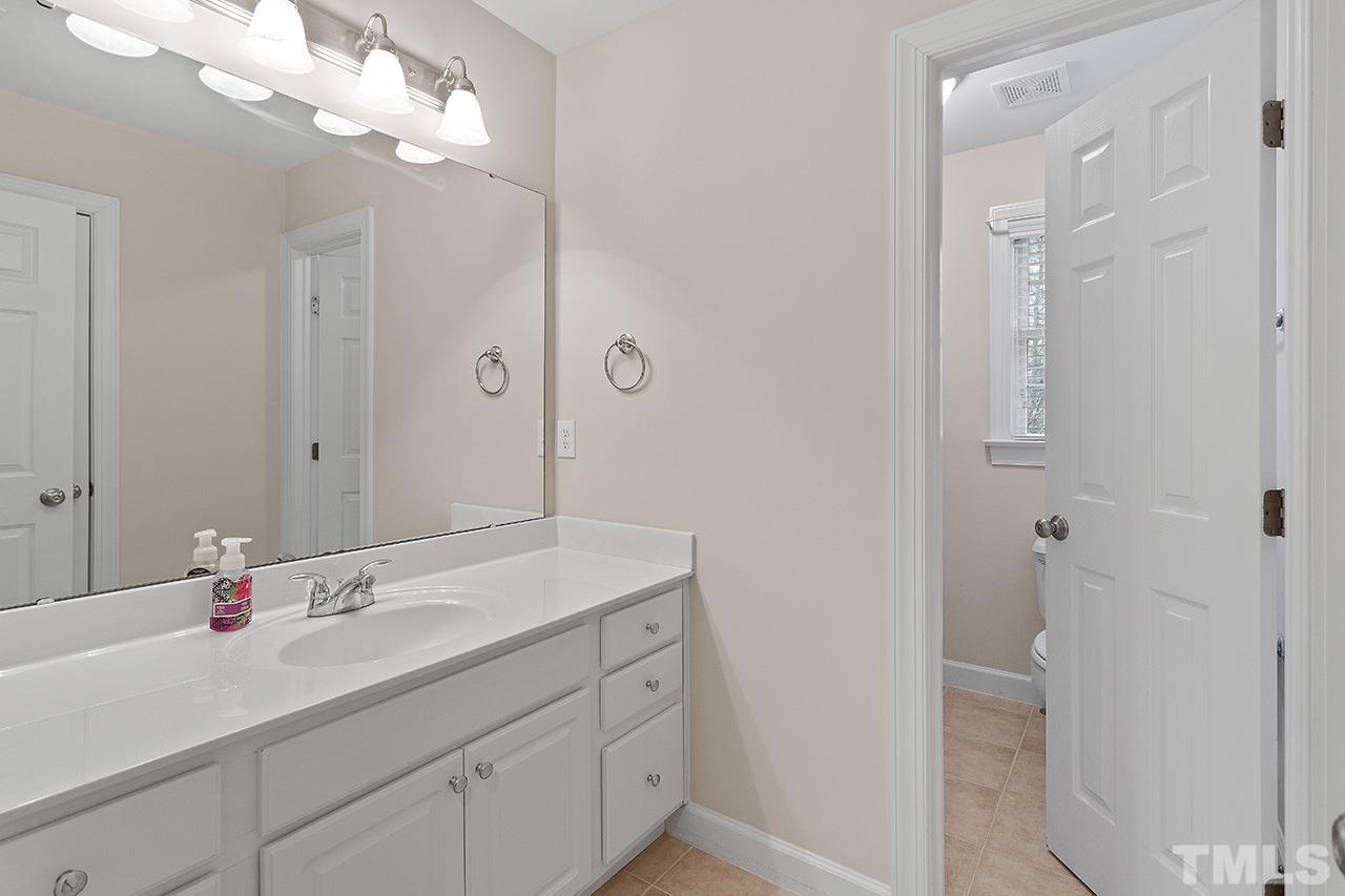 12724 Amoretto Way Raleigh, NC 27613 - Photo 35 of 44 a bathroom with a sink vanity and a mirror