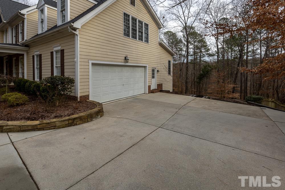 12724 Amoretto Way Raleigh, NC 27613 - Photo 40 of 44 a front view of a house with a yard and garage