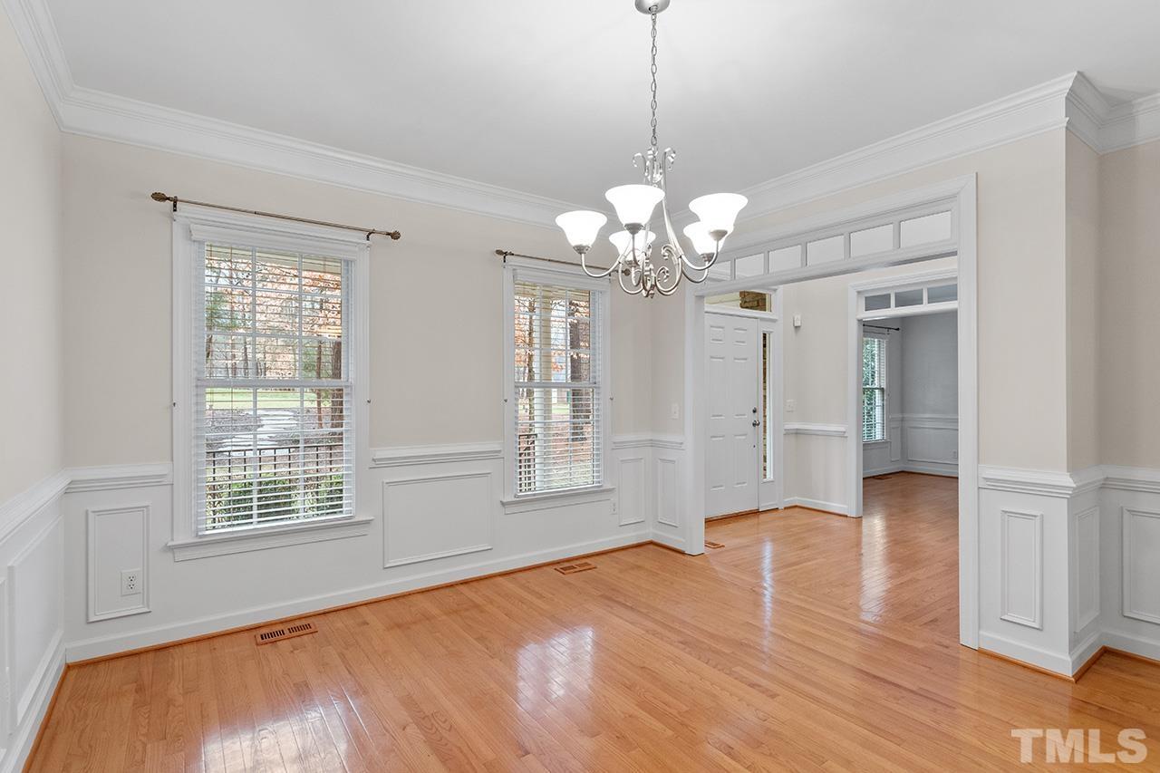 12724 Amoretto Way Raleigh, NC 27613 - Photo 6 of 44 a view of livingroom with chandelier front door and windows