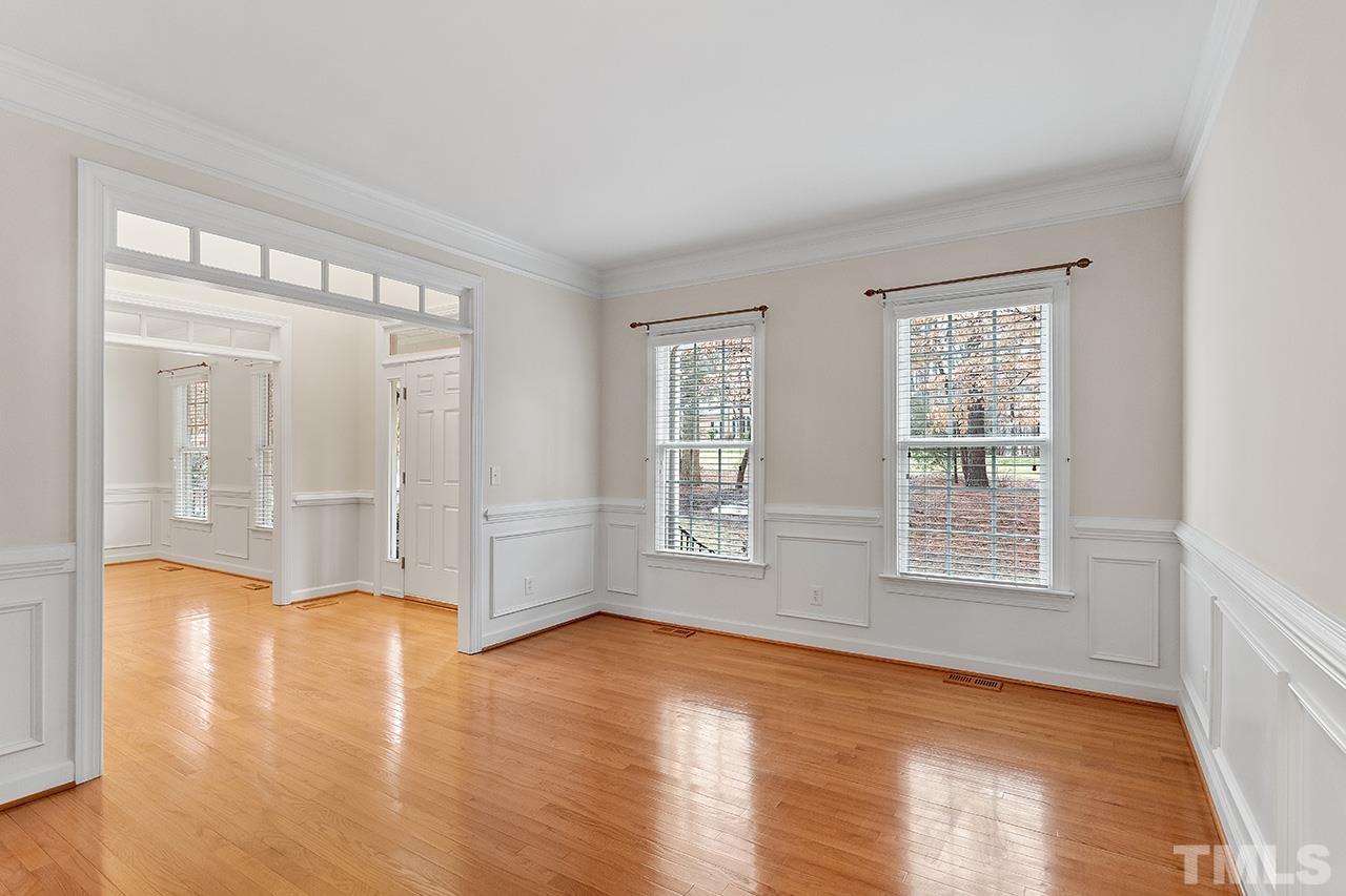 12724 Amoretto Way Raleigh, NC 27613 - Photo 8 of 44 a view of an empty room with wooden floor and a window