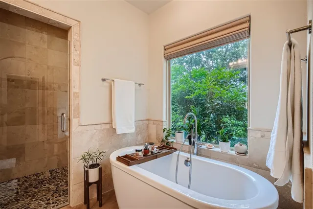 a white bath tub sitting next to a window