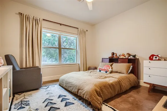 a bedroom with a bed and window