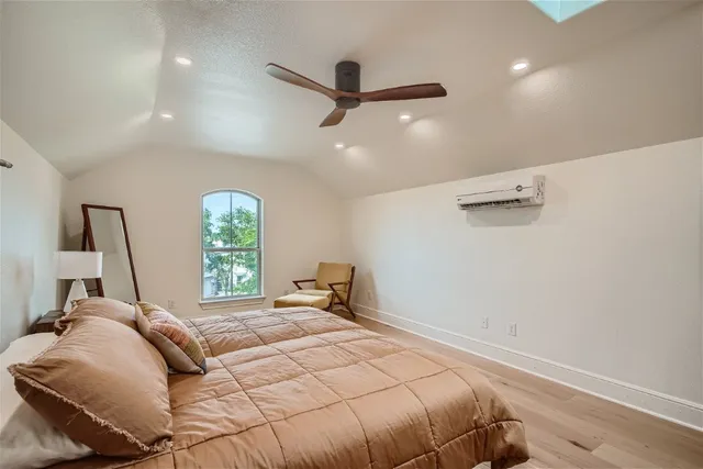 a bedroom with a bed and a large window