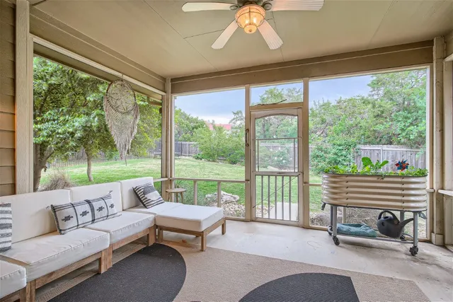a living room with furniture and a floor to ceiling window