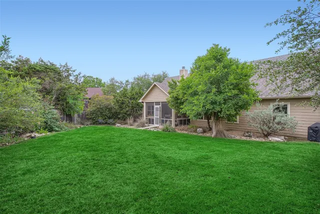 a view of a house with a yard and sitting area