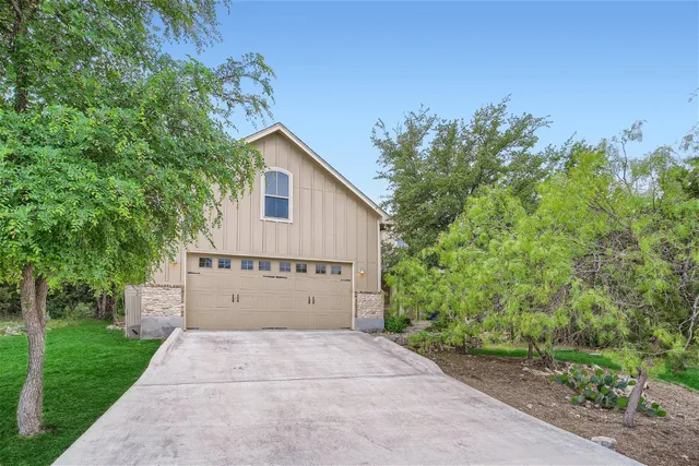 a view of a house with a yard and a garage