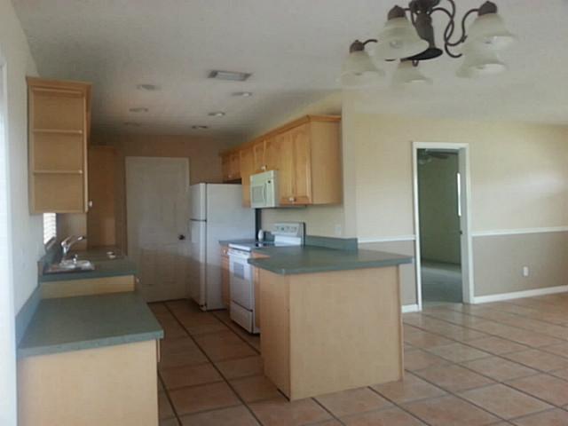 2080 Southeast Madison Street Stuart, FL 34997 - Photo 12 of 25 a kitchen with a sink and cabinets
