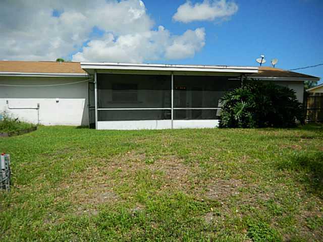 2080 Southeast Madison Street Stuart, FL 34997 - Photo 16 of 25 a view of house with backyard and garden