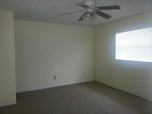 2080 Southeast Madison Street Stuart, FL 34997 - Photo 20 of 25 an empty room with a window and a fan