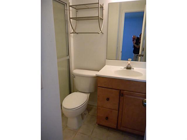 2080 Southeast Madison Street Stuart, FL 34997 - Photo 21 of 25 a bathroom with a toilet a sink and a mirror