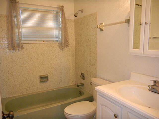 2080 Southeast Madison Street Stuart, FL 34997 - Photo 23 of 25 a bathroom with a sink toilet and shower