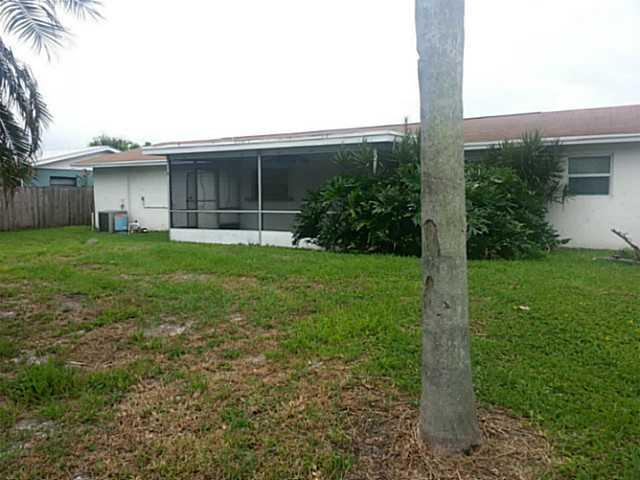 2080 Southeast Madison Street Stuart, FL 34997 - Photo 24 of 25 a view of a backyard with plants and a large tree