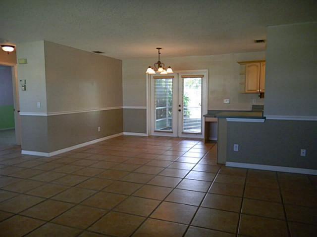 2080 Southeast Madison Street Stuart, FL 34997 - Photo 5 of 25 a kitchen with granite countertop a rug a stove a window and a counter top space