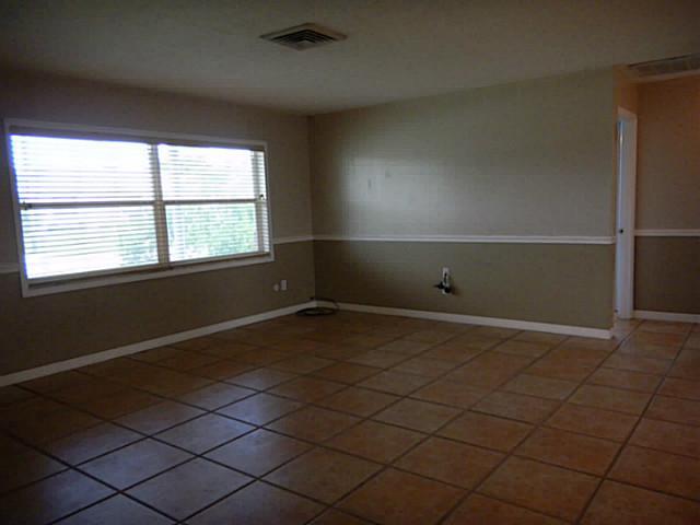 2080 Southeast Madison Street Stuart, FL 34997 - Photo 7 of 25 a room with a window and a table