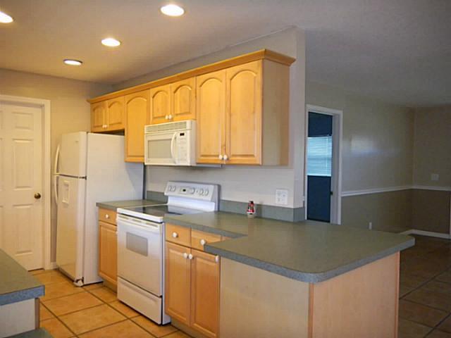 2080 Southeast Madison Street Stuart, FL 34997 - Photo 8 of 25 a kitchen with stainless steel appliances granite countertop a sink and a cabinets