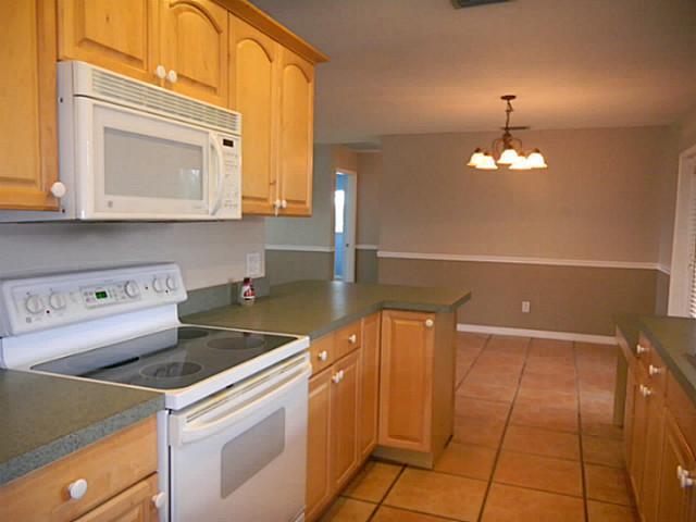 2080 Southeast Madison Street Stuart, FL 34997 - Photo 9 of 25 a kitchen that has a microwave and a stove