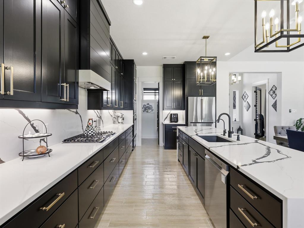 2016 Sonora Way Poolville, TX 76487 - Photo 11 of 40 a large kitchen with kitchen island granite countertop a sink and cabinets