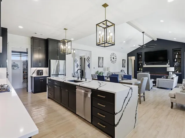 a large kitchen with stainless steel appliances lots of counter space