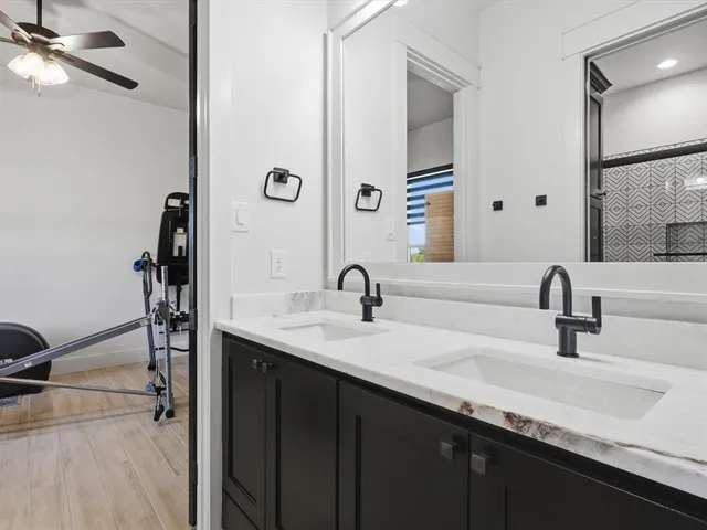 a bathroom with double vanity sinks and a mirror