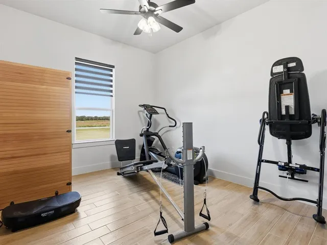 a view of a workspace with furniture and gym cycle