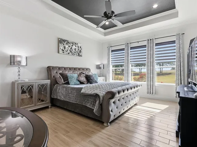 a bedroom with a large bed and a chandelier