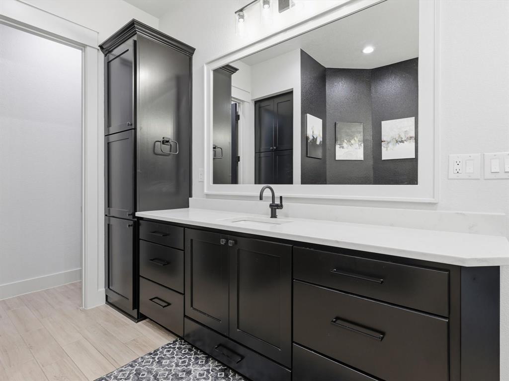 2016 Sonora Way Poolville, TX 76487 - Photo 29 of 40 a bathroom with a double vanity sink and a mirror