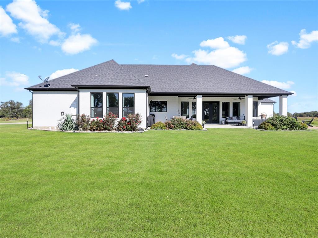 2016 Sonora Way Poolville, TX 76487 - Photo 32 of 40 a front view of a house with garden