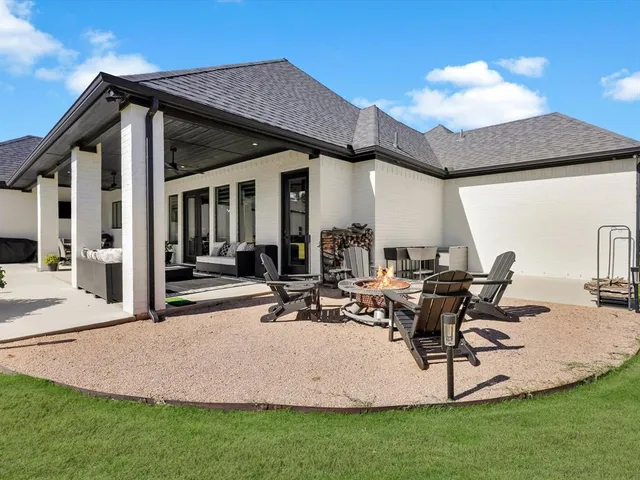a view of a house with backyard porch and sitting area