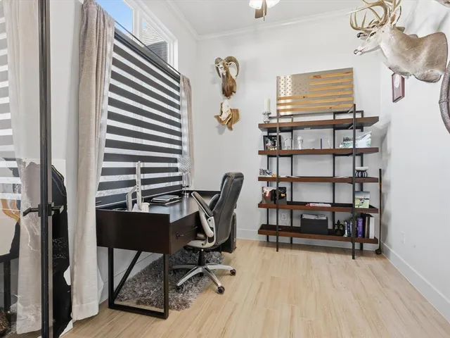 a view of a workspace with furniture and a book shelf