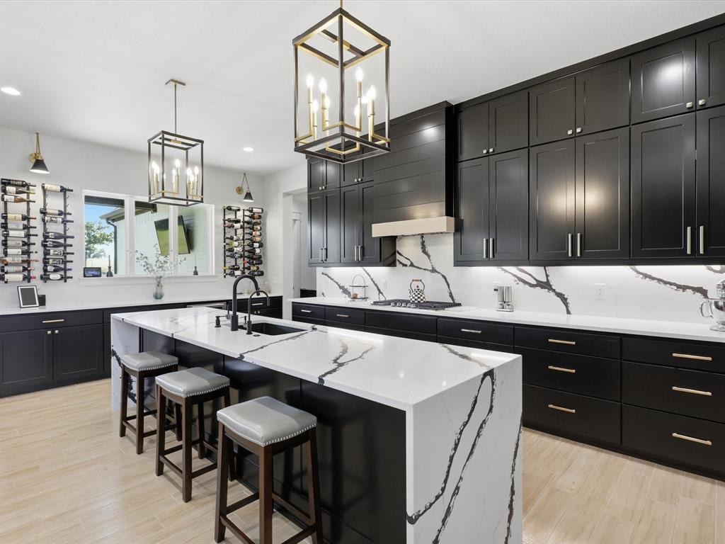 2016 Sonora Way Poolville, TX 76487 - Photo 8 of 40 a kitchen with stainless steel appliances kitchen island granite countertop a sink and a refrigerator